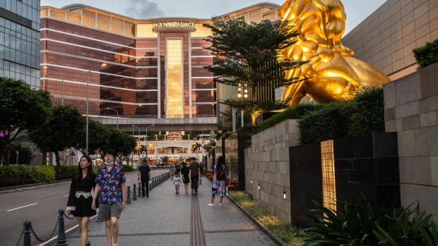 Wynn Macau casino resort, operated by Wynn Resorts Ltd., and a lion statue outside the MGM Cotai casino resort, developed by MGM China Holdings Ltd., in Macau. Photographer: Eduardo Leal/Bloomberg