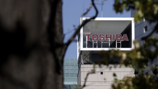 Signage for Toshiba Corp. displayed at the company's headquarters in Tokyo, Japan, on Wednesday, April 7, 2021. Toshiba surged its daily limit of 18% after confirming it received an initial buyout offer from CVC Capital Partners, setting the stage for potentially the largest private equity-led acquisition in years. Photographer: Kiyoshi Ota/Bloomberg