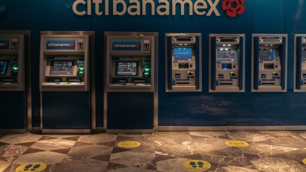 Customers wait in line to use the automatic teller machine (ATM) at a Banco Nacional de Mexico SA (Banamex) Citibanamex bank branch in Mexico City, Mexico, on Wednesday, Jan. 12, 2022. Citigroup Inc. is planning to exit retail-banking operations in Mexico, where it has its largest branch network in the world, as part of Chief Executive Officer Jane Fraser’s continued push to overhaul the firm’s strategy. Photographer: Jeoffrey Guillemard/Bloomberg