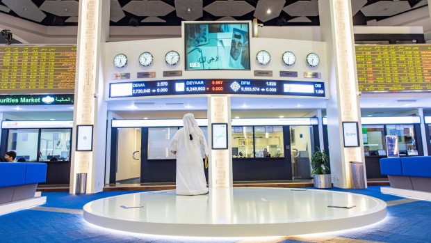 An investor looks up at a television news report at the Dubai Financial Market PJSC (DFM) in Dubai, United Arab Emirates, on Wednesday, Aug. 24, 2022. While not as intense as in other parts of the world, inflation is percolating in the oil-rich Gulf, with Dubai among countries in the region that have set aside billions of dollars in inflation relief. Photographer: Christopher Pike/Bloomberg