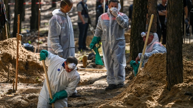 A forensics team works at the site of a mass grave near Izyum, Ukraine, in September. Photographer: Juan Barreto/AFP/Getty Images