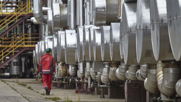 An employee examines pipework in the distillation plant of the PKN Orlen SA oil refinery in Plock, Poland, on Friday, July 17, 2020. Polish refiner PKN Orlen won conditional European Union approval to buy rival Grupa Lotos SA after agreeing on a “extensive” commitments package designed to allay potential competition concerns.