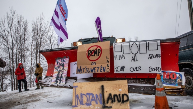 Signs hang from a snowplow during a protest near Belleville, Canada in 2020. Demonstrators blocked railroads and other infrastructure across Canada to protest TC Energy’s planned Coastal GasLink pipeline.