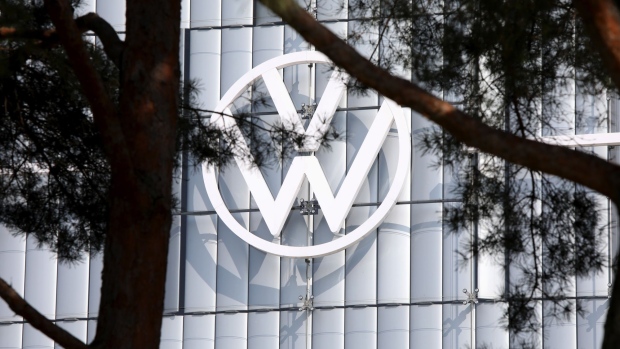 A Volkswagen AG (VW) logo on the automaker's Autostadt automobile delivery towers in Wolfsburg, Germany, on Friday, March 26, 2021. Volkswagen's stock started taking off last week as investors bought into the Germany company’s plan to supplant Tesla Inc. as the global leader in electric cars. Photographer: Liesa Johannssen-Koppitz/Bloomberg