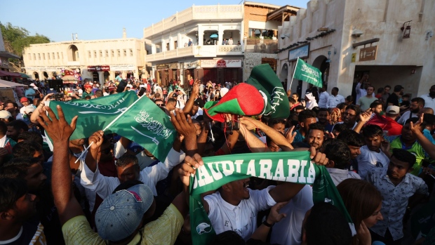 DOHA, QATAR - NOVEMBER 22: Saudi Arabia fans celebrate their side's victory in the Group C match against Argentina at Souq Waqif in the Mushayrib district on November 22, 2022 in Doha, Qatar. (Photo by Christopher Lee/Getty Images)