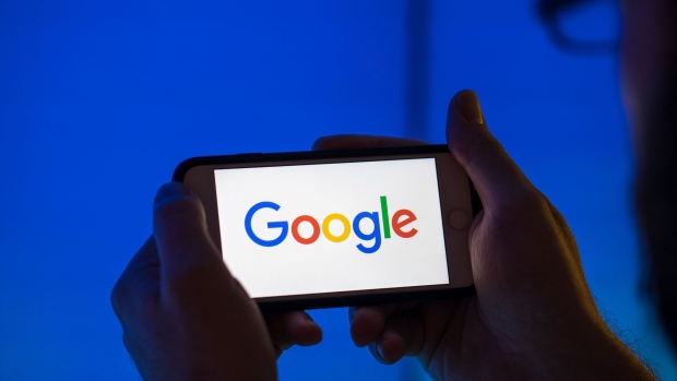 The logo of Google, a unit of Alphabet Inc., sits on an Apple Inc. iPhone smartphone in this arranged photograph in London, U.K., on Monday, Aug. 20, 2018. The NYSE FANG+ Index is an equal-dollar weighted index designed to represent a segment of the technology and consumer discretionary sectors consisting of highly-traded growth stocks of technology and tech-enabled companies. Photographer: Jason Alden/Bloomberg