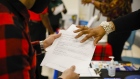 A job seeker receives information from a recruiter during a Miami-Dade County job fair in Miami, Florida.