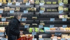 A customer shops in the prepared food section of the Trader Joe's Upper East Side Bridgemarket grocery store in New York, U.S., on Thursday, Dec. 2, 2021. The century-old vaulted market under the Queensboro Bridge has reopened on Thursday as a Trader Joe's.