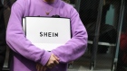 A customer holds a Shein bag outside the Shein Tokyo showroom in Tokyo, Japan, on Sunday, Nov. 13, 2022. Fast fashion retailer Shein opened its first permanent store in the world in the Harajuku district of Tokyo on Sunday, Nov. 13. Photographer: Noriko Hayashi/Bloomberg