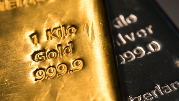 A one-kilogram gold bar sits on top of a one-kilogram silver bar at Gold Investments Ltd. bullion dealers in this arranged photograph in London, U.K., on Wednesday, July 29, 2020. Gold held its ground after a record-setting rally as investors awaited the outcome of a Federal Reserve meeting amid expectations policy makers will remain dovish, potentially spurring more gains. Photographer: Chris Ratcliffe/Bloomberg