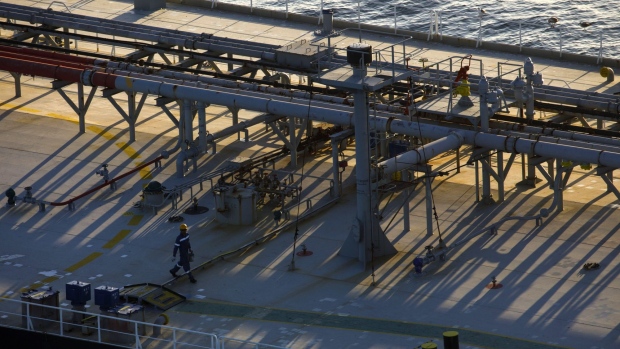 A crew member walks on the deck of an oil tanker anchored in the Pacific Ocean in this aerial photograph taken above Long Beach, California, U.S., on Friday, May 1, 2020. The volume of oil on vessels located just offshore the state peaked at 26 million barrels over the weekend, about a quarter of the world's daily consumption, before dropping to 22 million barrels on Monday, according to Paris-based Kpler SAS, which tracks tanker traffic. Photographer: Patrick T. Fallon/Bloomberg