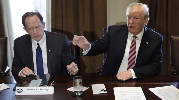U.S. President Donald Trump, right, speaks while Senator Pat Toomey, a Republican from Pennsylvania, listens during a meeting with bipartisan members of Congress on trade in the Cabinet Room of the White House in Washington, D.C., U.S., on Tuesday, Feb. 13, 2018. Republican lawmakers cautioned Trump in a White House meeting against levying tariffs on steel and aluminum imports, warning that it would raise prices of the metals and potentially cost the U.S. jobs in other industries including car manufacturing. Photographer: Yuri Gripas/Bloomberg