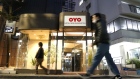 Pedestrians walk past an Oyo hotel, operated by Oyo Hotels Japan G.K., in Tokyo, Japan, on Monday, Jan. 27, 2020. Oyo has drawn particular attention in SoftBank Group Corp.’s portfolio of startups because of its similarities to WeWork. Both are trying to change traditional real estate businesses with technology. Both have charismatic young founders. Now, skeptics say Oyo could also fall short, further undermining Son’s grand ideas about technology investing.
