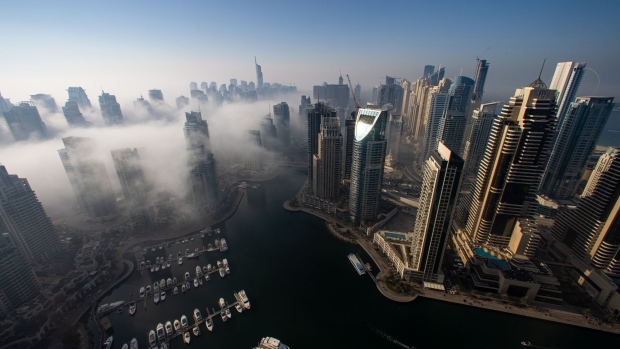 Morning fog shrouds residential and commercial skyscrapers in the Jumeirah Lake Towers and Dubai Marina districts of Dubai, United Arab Emirates, on Sunday, Jan. 17, 2021. Dubai is hoping one of the world’s fastest vaccination programs and rapid testing technology will help achieve its goal of holding the Expo 2020 event this year, after the coronavirus pandemic forced a delay. Photographer: Christopher Pike/Bloomberg