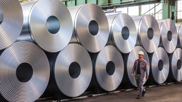 An employee passes rolls of steel at the Salzgitter AG steel plant in Salzgitter, Germany, on Monday, July 13, 2020. Europe is pinning its green hopes on hydrogen in a plan that sees hundreds of billions euros in investment flowing into the clean technology and fueling a climate-friendly economic recovery. Photographer: Rolf Schulten/Bloomberg