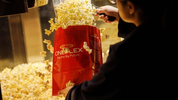 An employee fills a bag of popcorn in the concessions area inside a Cineplex Cinemas movie theater in Toronto, Ontario, Canada on Monday, Feb. 3, 2020. Britain's Cineworld Group Plc is on track to become North America's biggest operator of movie theaters with its plan to buy Canada's Cineplex Inc. for C$2.15 billion ($1.64 billion). Photographer: Cole Burston/Bloomberg