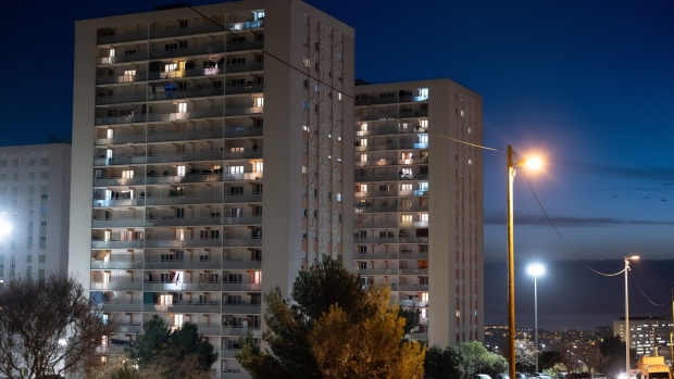 Lights on inside homes within apartment blocks in the Northern districts of Marseille, France, on Thursday, Nov. 24, 2022. The French governments 9.7 billion ($10 billion) offer to buy out minority shareholders of Electricite de France SA (EDF) will take the nationalization of the debt-laden nuclear giant a step closer.