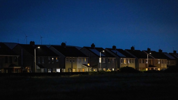 Partially lit residential homes near the steel works operated by Tata Steel Ltd. in Port Talbot, UK, on Wednesday, Aug. 17, 2022. Europe's heavy industry is buckling under surging power costs which are hitting energy-intensive manufacturers the hardest. Photographer: Hollie Adams/Bloomberg