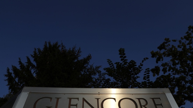Light reflects on signage at sunset near the Glencore Plc headquarters office in Baar, Switzerland, on Friday, July 6, 2018. Glencore will buy back as much as $1 billion of its shares, a move that may soothe investor concerns after the worlds top commodity trader was hit by a U.S. Department of Justice probe earlier this week.
