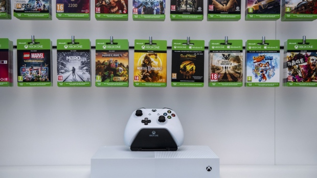 An Xbox One controller sits on display below gaming passes at the new Microsoft Corp. flagship store in central in London, U.K., on Tuesday, July 9, 2019. Apple Inc.’s flagship central London retail store gets a new neighbor on Thursday, as Microsoft Corp. opens its inaugural European high-street presence just meters away.