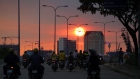 Motorcyclists travel along a road during sunset in Ho Chi Minh City, Vietnam, on Tuesday, Jan. 10, 2017. Vietnam's economy expanded more than 6 percent for a second year in 2016, defying a regional slowdown to remain one of the world's best performers as retails sales rose 10.2 percent. Photographer: Linh Luong Thai/Bloomberg