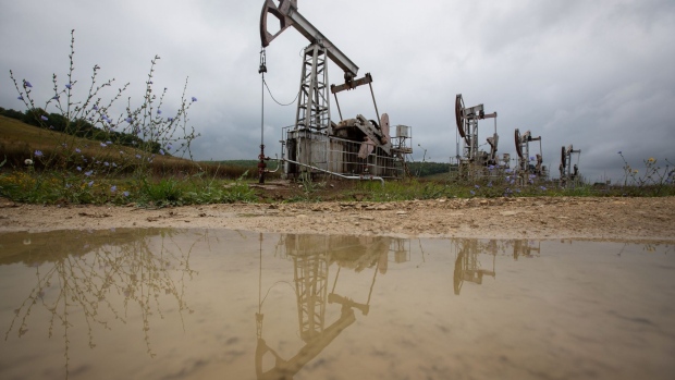 Oil pumping jacks, also known as "nodding donkeys", operate in an oilfield near Almetyevsk, Russia, on Sunday, Aug. 16, 2020. Oil fell below $42 a barrel in New York at the start of a week that will see OPEC+ gather to assess its supply deal as countries struggle to contain the virus that’s hurt economies and fuel demand globally. Photographer: Andrey Rudakov/Bloomberg