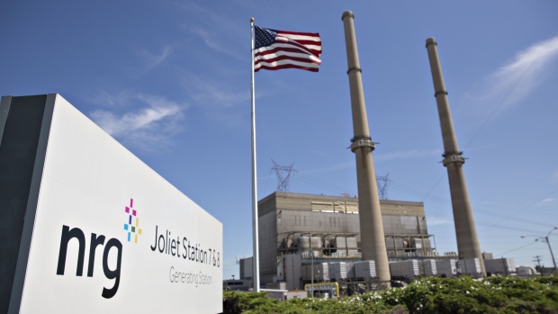 An American flag flies outside the NRG Energy Inc. Joliet Generating Station in Joliet, Illinois, U.S., on Wednesday, July 26, 2017. Coal-fired power plants employ more people than mines, and they're shutting down all over the country. Cheap natural gas, the rise of renewables backed by tax credits, and subsidies for nuclear energy will likely combine to keep the trend going and leave more people out of work.