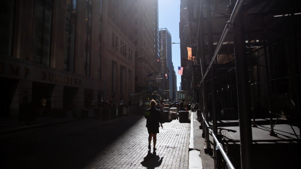 A pedestrian on Wall Street near the New York Stock Exchange (NYSE) in New York, U.S., on Tuesday, Sept. 7, 2021. Equities retreated from near-record highs as U.S. trading resumed after the Labor Day holiday. Photographer: Michael Nagle/Bloomberg