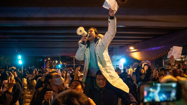 A demonstrator holds a blank sign and chants slogans during a protest in Beijing, on Nov. 28.