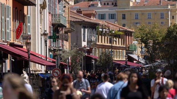 Shoppers and tourists walk along Rue Saint-Francois de Paul in Nice, France, on Wednesday, Aug. 24, 2022. French Finance Minister Bruno Le Maire said France is doing a better job containing inflation than its European counterparts and that he expects the rate to stay below 10%. Photographer: Hollie Adams/Bloomberg