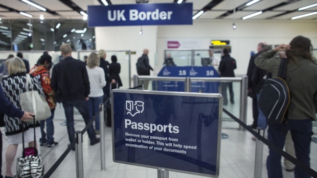 Border Force check the passports of passengers arriving at Gatwick Airport in London.