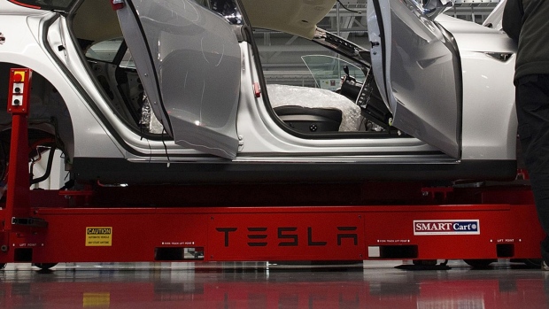 Tesla Motor Inc. associates work on the Model S electric car at the company's factory in Fremont, California.