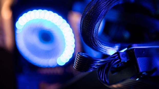 Lights illuminate graphic processing unit (GPU) cables inside a 'mining rig' computer, used to mine the Electroneum cryptocurrency, in Budapest, Hungary, on Wednesday, Jan. 31, 2018. Cryptocurrencies are not living up to their comparisons with gold as a store of value, tumbling Monday as an equities sell-off in Asia extended the biggest rout in global stocks in two years. Photographer: Akos Stiller/Bloomberg