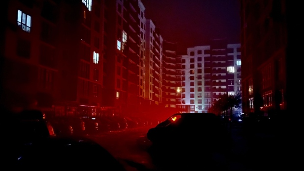 Light from homes within apartment blocks Pedestrians during a blackout in Kyiv, Ukraine, on Tuesday, Dec. 6, 2022. Ukrainians have been no strangers to hardship over the past century, but their dogged resilience and solidarity in the face of Russian bombardment has been an enduring image of a war that started at the tail end of last winter.