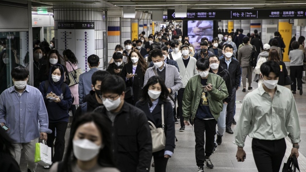 Morning commuters walk through a subway station in Seoul, South Korea, on Monday, April 18, 2022. Starting Monday, there is no social distancing rules except for wearing masks, culminating the country’s drive to “return lives to normal” with a strategy that has stood out for preventing an economic downturn while keeping the death rate relatively low.