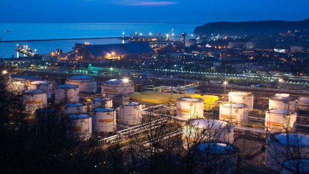Oil storage tanks stand illuminated at night at the RN-Tuapsinsky refinery, operated by Rosneft Oil Co., in Tuapse, Russia, on Sunday, March 22, 2020. Oil resumed gains on signs that the world’s biggest producers are moving toward a deal to end their price war and cut output.