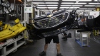 An employee carries a General Motors Co. (GM) Chevrolet bumper at the Magna International Inc. Polycon Industries auto parts manufacturing facility in Guelph, Ontario, Canada, on Thursday, Aug. 30, 2018. Canadian stocks and the dollar extended gains Monday on news of a U.S.-Mexican trade agreement, shrugging off U.S. President Donald Trump's threats that Canada might be frozen out and instead face auto tariffs.