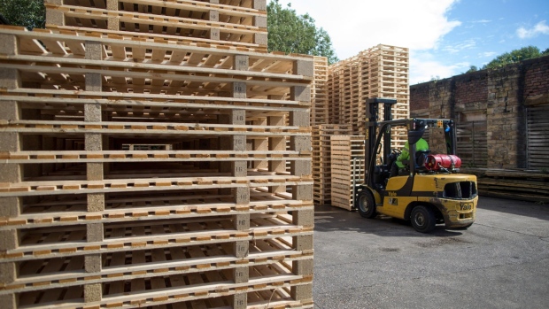 An employee uses a forklift truck to move a stack of non heat treated wooden pallets at Shaw Pallet Ltd. in Huddersfield, U.K., on Tuesday, Aug. 25, 2020. From January, wooden pallets moving goods between the U.K. and EU will need to comply with ISPM-15 -- an international rule that requires them to be baked to 56 degrees Celsius for at least 30 minutes to prevent the spread of pests and diseases. Photographer: Chris Ratcliffe/Bloomberg