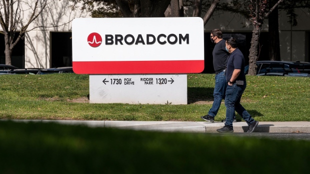 People wearing protective masks walk past the Broadcom Inc. headquarters in San Jose, California, U.S., on Tuesday, March 2, 2021. Broadcom Inc. is scheduled to release earnings figures on March 4.