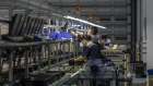 Employees on an assembly line for refurbished computer consoles at the Sketch Global facility in the Lingang Special Area and Comprehensive Zone in Shanghai, China, on Thursday, Aug. 25, 2022. Lingang, a 120-square-kilometer (46 -square-mile) patch of land southeast of Shanghai roughly a sixth the size of Singapore, was designated by Chinese President Xi Jinping in 2018 as the country’s top free-trade area, to be modeled after the likes of Singapore and Dubai. Photographer: Qilai Shen/Bloomberg