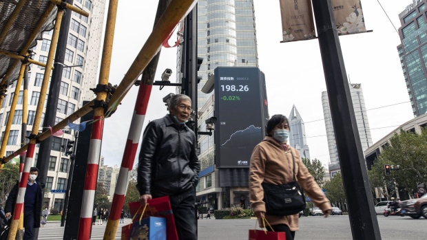 A public screen displaying stock figures in Shanghai, China, on Wednesday, Dec. 7, 2022. China eased a range of Covid restrictions Wednesday, including allowing some people to quarantine at home rather than in centralized camps and scrapping virus tests to enter most public venues — a sharp change in national strategy to quell public discontent and fire up the economy again. Photographer: Qilai Shen/Bloomberg