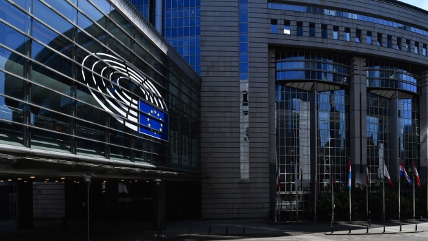 Pedestrians pass the European Parliament's Paul-Henri Spaak building in Brussels, Belgium.
