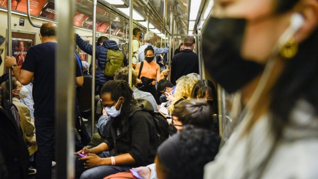 Commuters ride a subway in New York, US, on Wednesday, May 25, 2022. New York City's subway system is carrying fewer riders than expected this year as crime has spiked, including a fatal shooting on Sunday and a violent subway attack last month that shook the city.