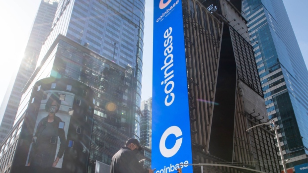 Monitors display Coinbase signage during the company's initial public offering at the Nasdaq MarketSite in New York on April 14.