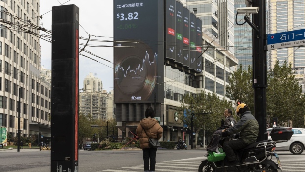 A public screen displaying stock figures in Shanghai, China, on Wednesday, Dec. 7, 2022. China eased a range of Covid restrictions Wednesday, including allowing some people to quarantine at home rather than in centralized camps and scrapping virus tests to enter most public venues — a sharp change in national strategy to quell public discontent and fire up the economy again. Photographer: Qilai Shen/Bloomberg