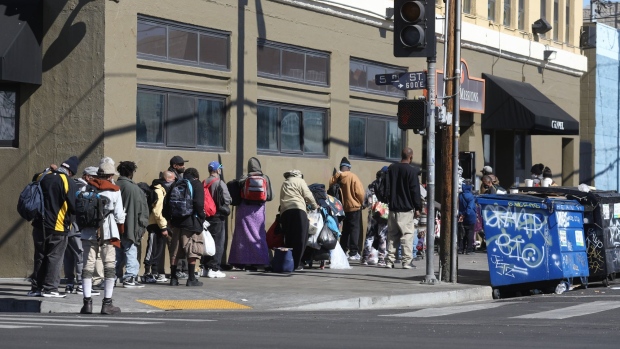 People experiencing homelessness wait in line at a mission in the Skid Row neighborhood of Los Angeles.