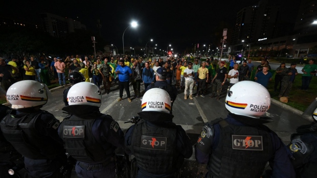 Supporters of President Jair Bolsonaro confront military police during a protest in Brasilia on Dec. 12. Photographer: Evaristo SA/AFP/Getty Images