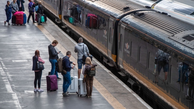 Rail passengers wait on a platform during a national rail strike at London King's Cross railway station in London, UK, on Wednesday, Oct. 5, 2022. Two rails unions planned walkouts on Oct. 5, when people will be making their way home from the Conservative Party Annual Conference in Birmingham.