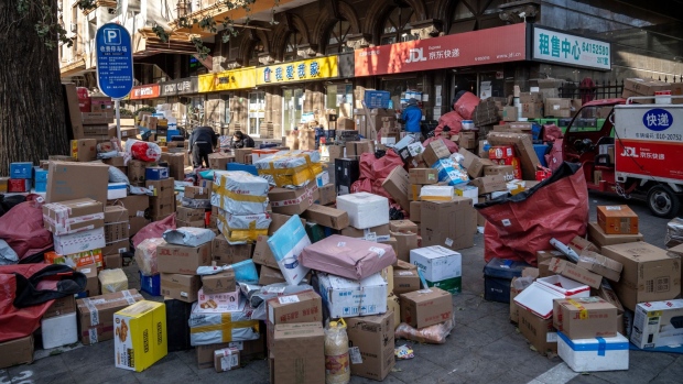 Packages outside a delivery center in Beijing, China, on Tuesday, Dec. 13. 2022. China's abrupt ending of its Covid Zero policy injects more uncertainty into an already fragile economy, raising the prospect of looser fiscal and monetary policy and more easing in the property market to bolster growth.