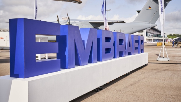 A sign for Embraer SA at the Singapore Airshow held at the Changi Exhibition Centre in Singapore, on Tuesday, Feb. 15, 2022. The air show runs through Feb. 18. Photographer: Lauryn Ishak/Bloomberg